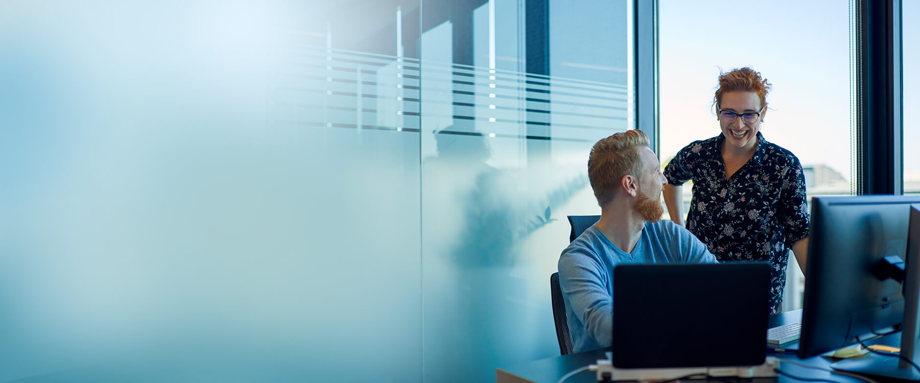 Zwei Personen sprechen in einem Büro