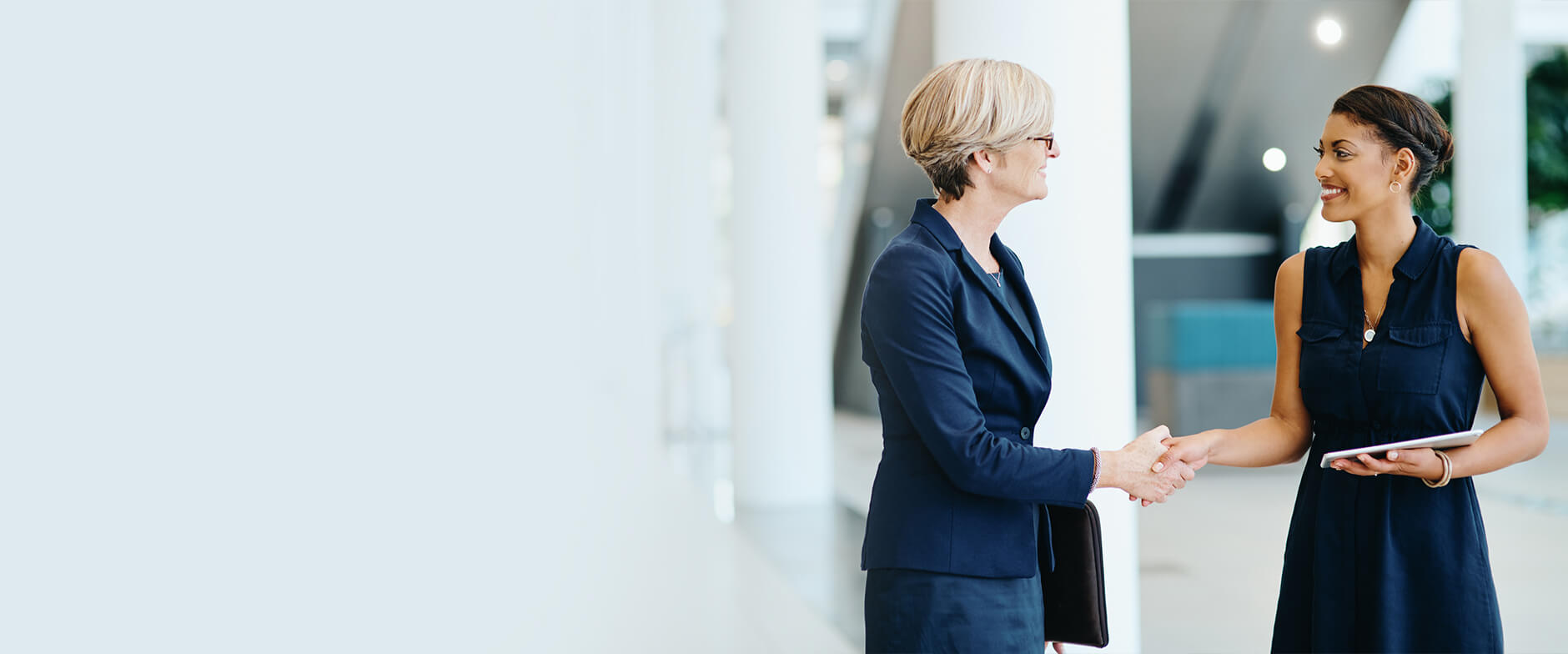 two people in business attire shaking hands