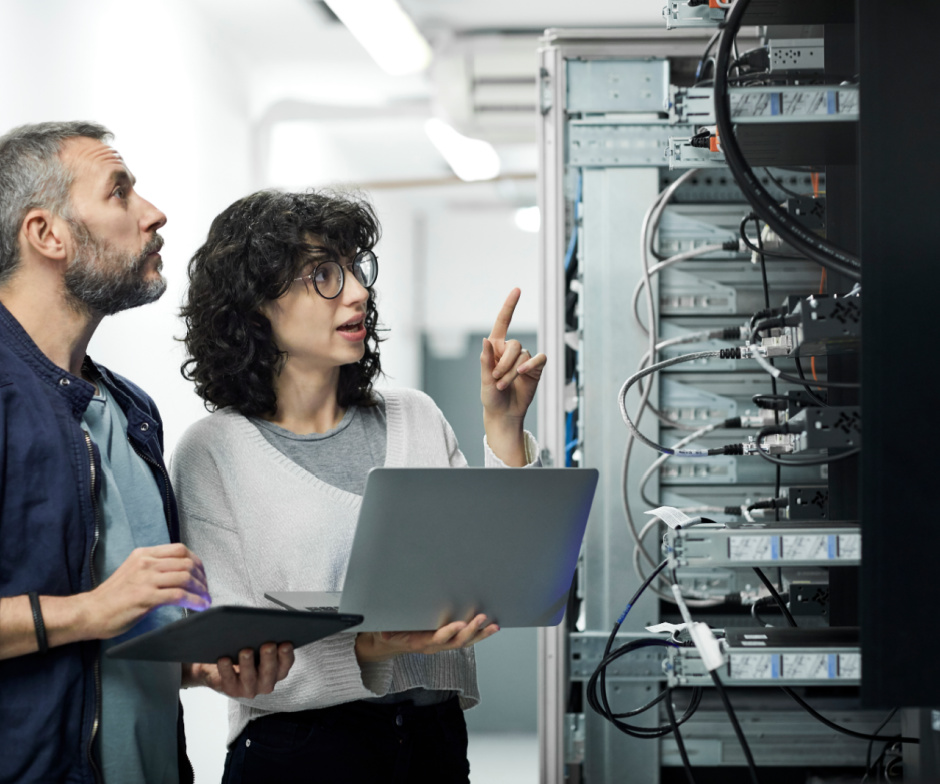 two people talking near a server rack