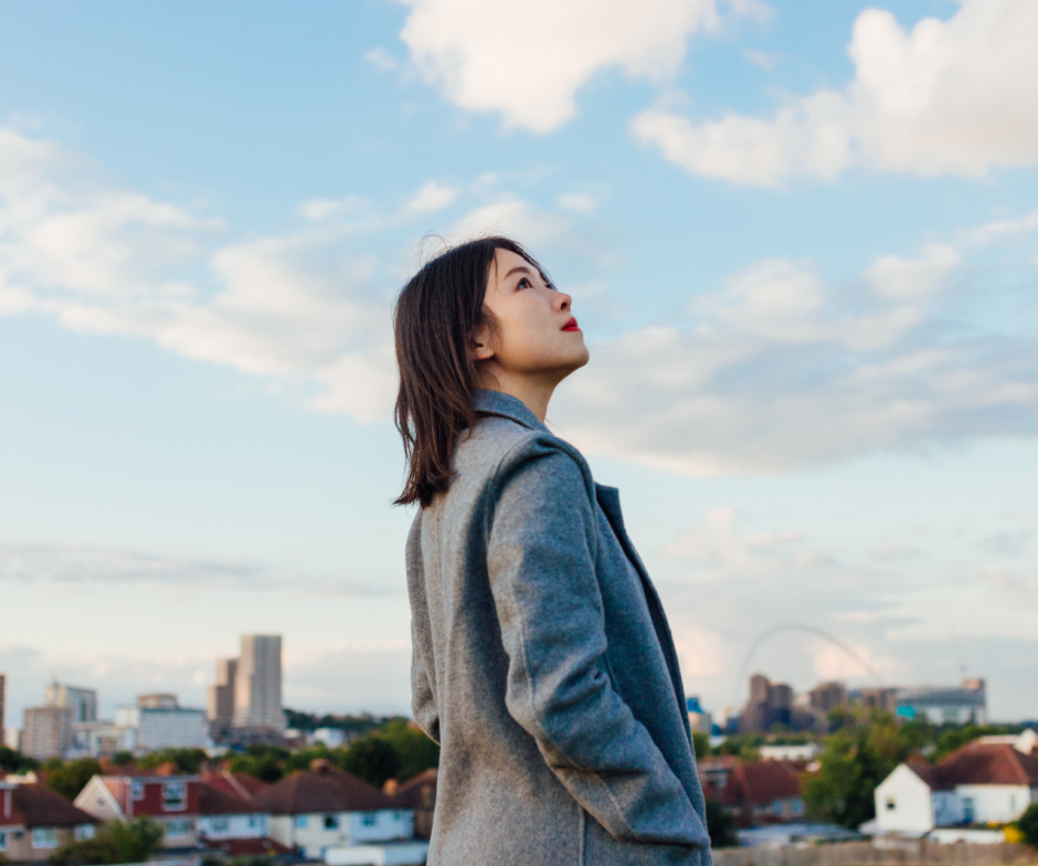 women dressed up in business suit and looking at the sky