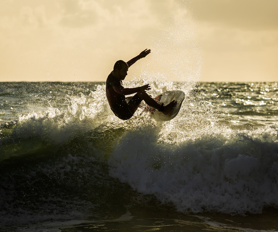 person surfing in ocean at sunset time