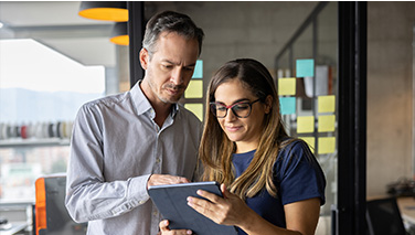 Two professionals looking at tablet screen